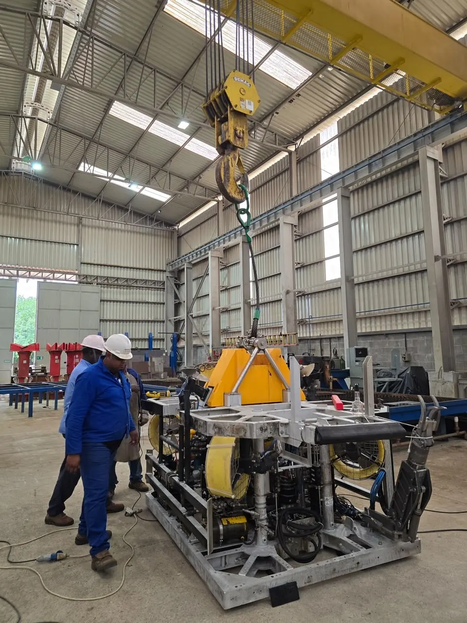 Team handling an ROV with the overhead crane